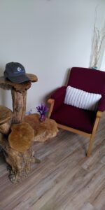 An armchair and a small table with different levels made from cross sections of a tree trunk